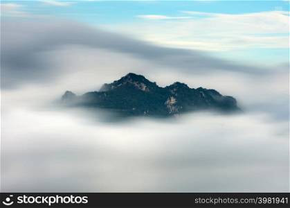 Beautiful long exposure Landscape in the morning time during sunrise with fog above the mountain, White fluffy clouds moving softly on cloudy, Pang puay Mae moh Lampang, Thailand.. Morning with fog above the mountain,