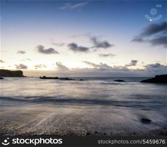 Beautiful long exposure landscape of beach at sunrise
