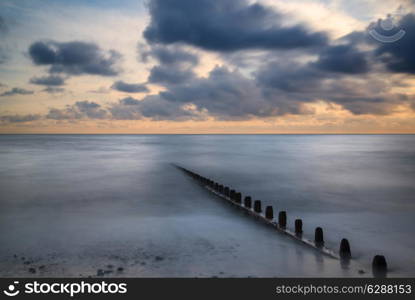 Beautiful long exposure vibrant conceptual image of ocean at sunset