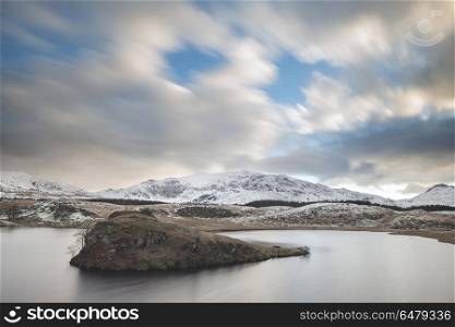 Beautiful long exposure Winter landscape image of Llyn y Dywarch. Beautiful Winter landscape image of Llyn y Dywarchen in Snowdonia National Park