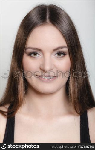 Beautiful long hair girl in sportwear young woman portrait on gray background.