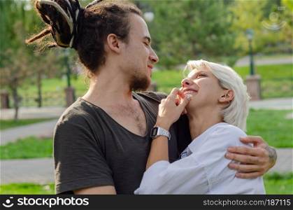 Beautiful loving couple is spending time together in the park.the young man took his love in his arms.
