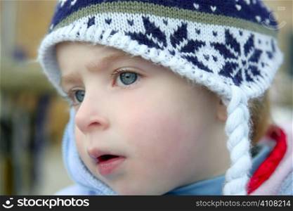 Beautiful macro close up portrait of little toddler girl, snow hat