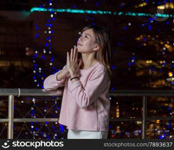 Beautiful Malaysian female with bright lights of city in background