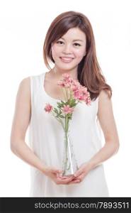 Beautiful Malaysian woman with pink flowers in a vase