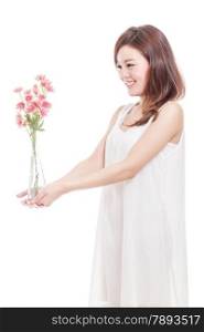 Beautiful Malaysian woman with pink flowers in a vase