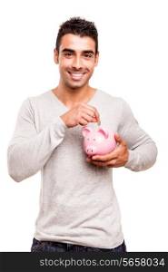 Beautiful man saving money to a piggy bank
