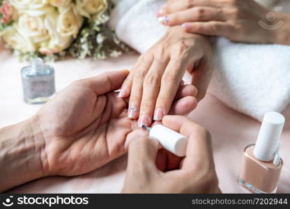 Beautiful manicure nails paint with glitter and varnish in nail salon