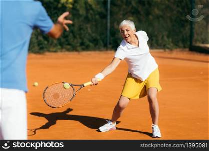Beautiful Mature Active Woman Playing Tennis