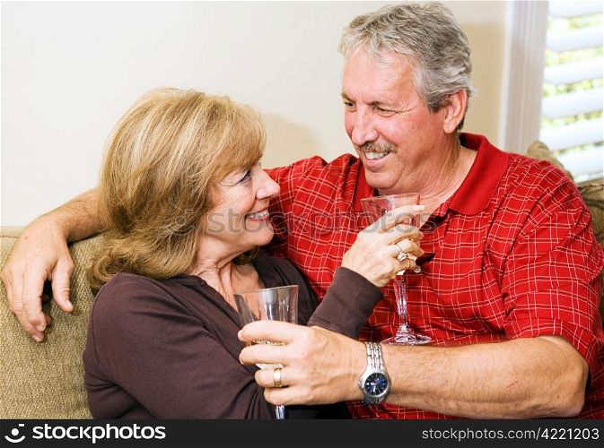 Beautiful mature couple relaxing together with a glass of wine.