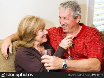 Beautiful mature couple relaxing together with a glass of wine.
