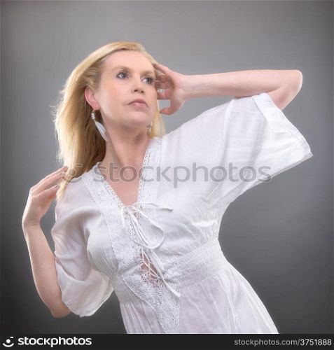 Beautiful mature woman wearing summer shirt, studio shot