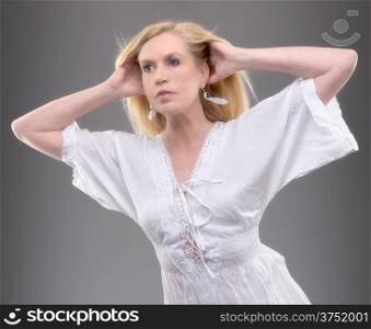 Beautiful mature woman wearing summer shirt, studio shot