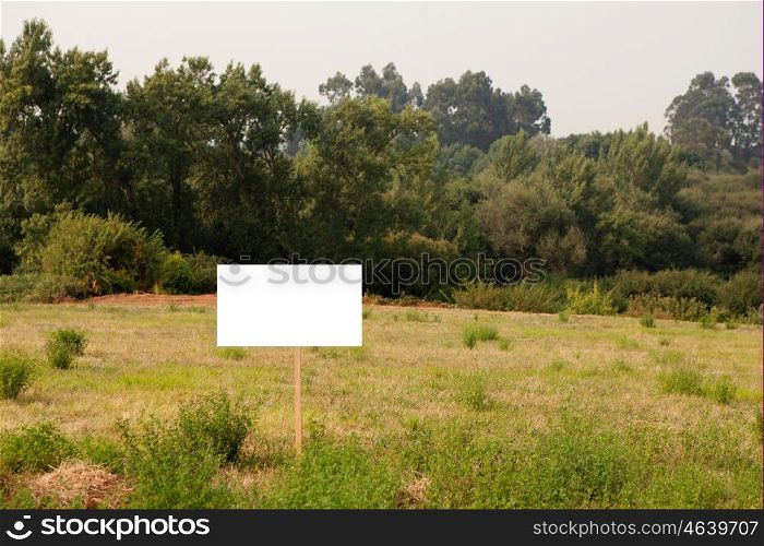 Beautiful meadow with a blank cartel for advertising