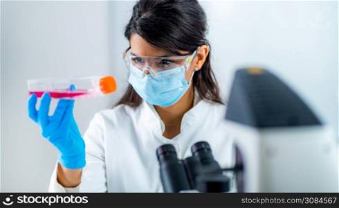 Beautiful Medicine or Molecular Biology Student in Laboratory , Working with Cell Culture. Beautiful Female Medicine or Molecular Biology Student in Laboratory