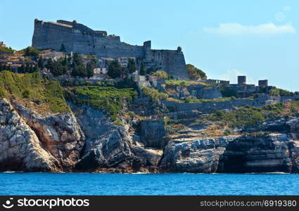 Beautiful medieval fisherman town of Portovenere (UNESCO Heritage Site) view from sea (near Cinque Terre, Liguria, Italy). Fortress Castello Doria (build in 12th century).