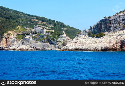 Beautiful medieval fisherman town of Portovenere (UNESCO Heritage Site) view from sea (near Cinque Terre, Liguria, Italy). Fortress Castello Doria and church Chiesa di San Pietro.