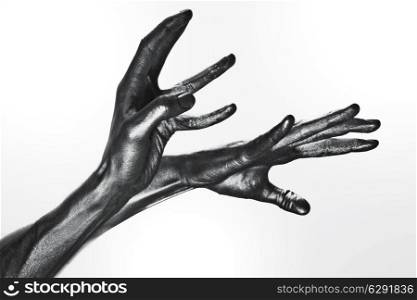 beautiful men metal hands with long fingers on white background