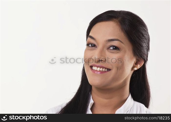 Beautiful mid adult woman smiling over white background