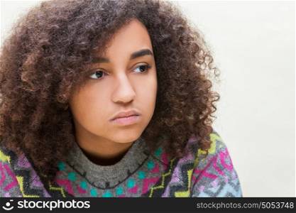 Beautiful mixed race African American girl teenager female young woman sad depressed or thoughtful
