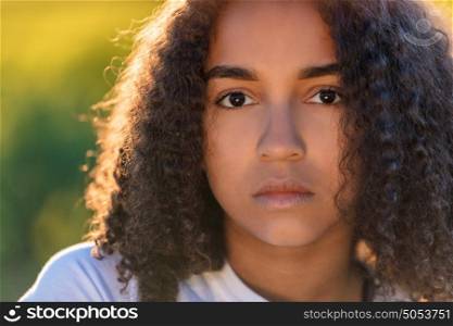 Beautiful mixed race African American girl teenager female young woman sad depressed or thoughtful