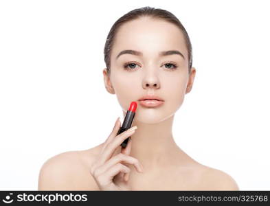 Beautiful model girl holding lipstick tube makeup on white background