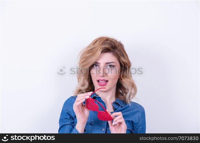 Beautiful model Girl in heart shaped sunglasses with jean shirt.Concept image with isolated on white background
