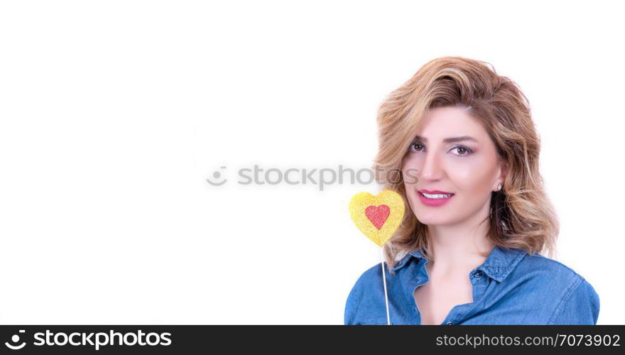 Beautiful model Girl with Valentine Heart shaped stick in hand.Attractive woman holding red love heart stick isolated on white background