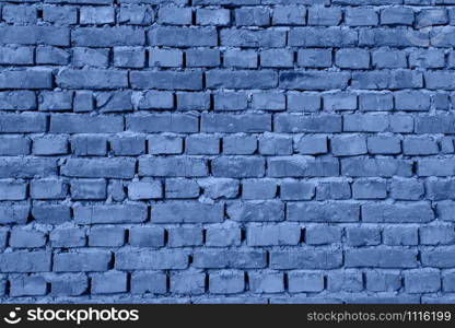 Beautiful modern funky loft wall background. Toned Blue pattern of style design decorative real stone wall surface. Trendy long banner toned in classic blue - color of the 2020 year. Stonewall architectural background toned in blue