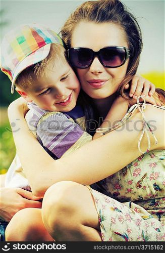 Beautiful mom hugging her cute little son