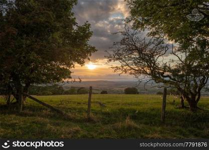 Beautiful moody Summer sunset landscape over English countryside with lovely light