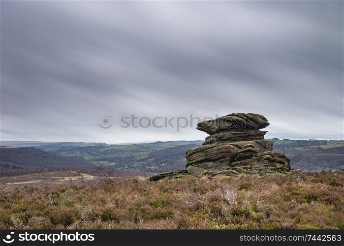 Beautiful moody Winter landscape image of Peak District in England during dramatic afternoon light