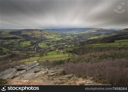 Beautiful moody Winter landscape image of Peak District in England during dramatic afternoon light