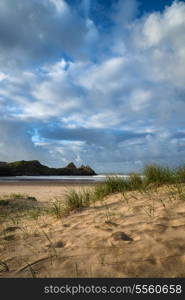 Beautiful morning landscape over sandy beach Three Cliffs Bay