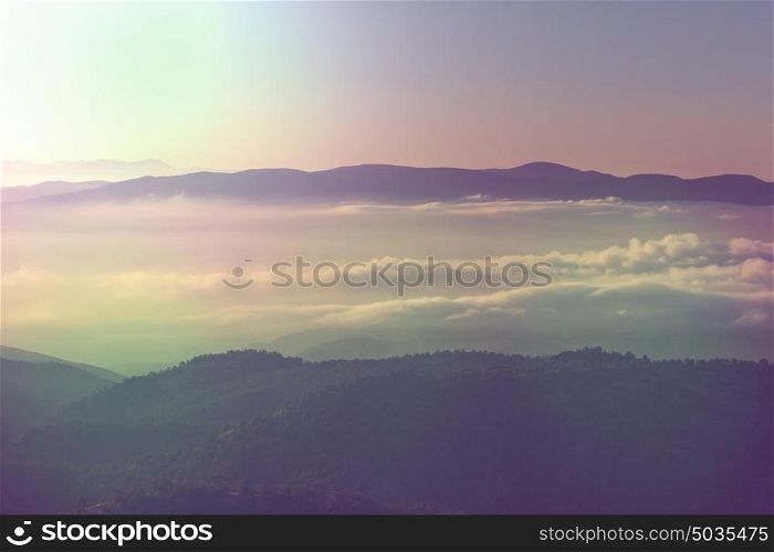 Beautiful morning scene in the mountains. Fog at sunrise.