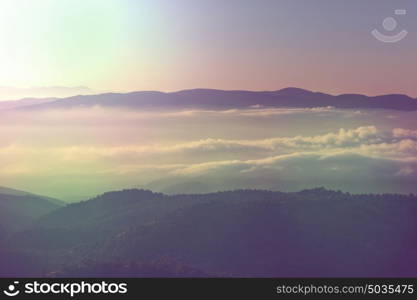 Beautiful morning scene in the mountains. Fog at sunrise.