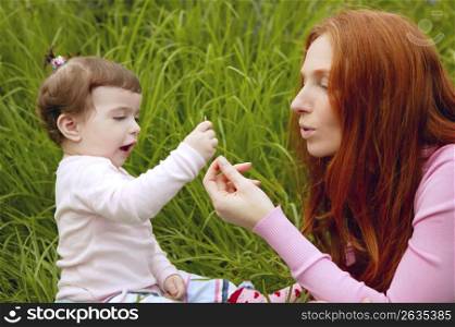beautiful mother and baby little girl outdoor park garden grass playing