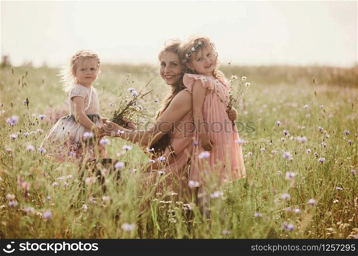 Beautiful Mother And her little daughter outdoors. Nature. Beauty Mum and her Child playing in Park together. Outdoor Portrait of happy family. Happy Mother&rsquo;s Day Joy. Mom and Baby. Beautiful Mother And her little daughter outdoors. Nature. Outdoor Portrait of happy family. Happy Mother&rsquo;s Day Joy.