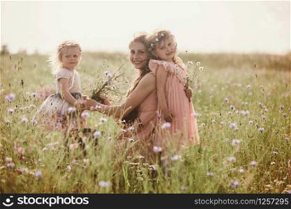 Beautiful Mother And her little daughter outdoors. Nature. Beauty Mum and her Child playing in Park together. Outdoor Portrait of happy family. Happy Mother&rsquo;s Day Joy. Mom and Baby. Beautiful Mother And her little daughter outdoors. Nature. Outdoor Portrait of happy family. Happy Mother&rsquo;s Day Joy.