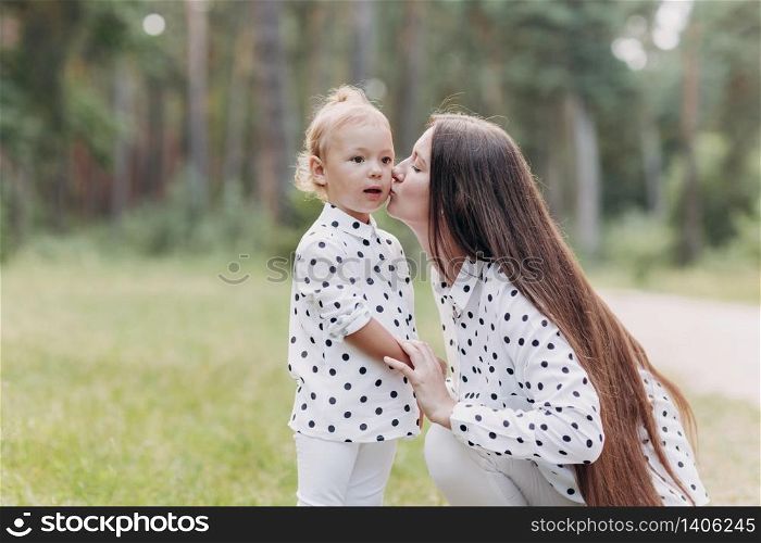 Beautiful Mother And her little daughter outdoors. Nature. Beauty Mum and her Child playing in Park together. Kissing and hugging happy family. Happy Mother&rsquo;s Day Joy. Mom and Baby. Beautiful Mother And her little daughter outdoors. Nature. Beauty Mum and her Child playing in Park together. Kissing and hugging happy family. Happy Mother&rsquo;s Day Joy. Mom and Baby.