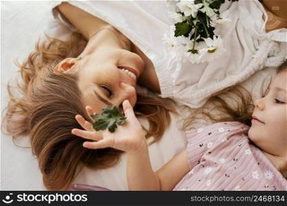 beautiful mother daughter with bouquet delicate spring flowers