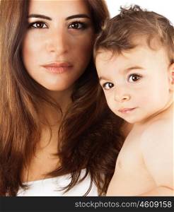 Beautiful mother holding baby boy, mom carry cute child adorable small son, happy family picture, mom and kid modeling indoor, healthy toddler and mommy, brunette Arabic models, happiness concept