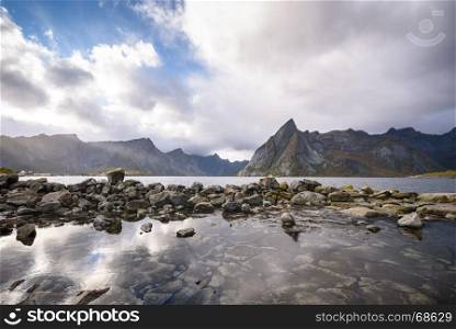 Beautiful mountain and lake landscape in a morning with blue sky and cloudy, Lofoten, Norway