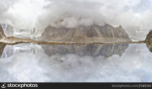 Beautiful mountain lake with reflection under the clouds. mountain lake under clouds