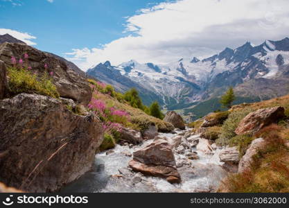 Beautiful mountain landscape with stream near Alps, Switzerland in the summer Swiss Europe. Beautiful mountain landscape with stream near Alps, Switzerland in the summer in blue sky