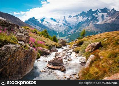 Beautiful mountain landscape with stream near Alps, Switzerland in the summer Swiss Europe. Beautiful mountain landscape with stream near Alps, Switzerland in the summer in blue sky