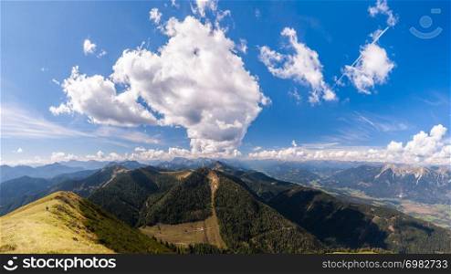 Beautiful mountain panorama on Italian Alps with blue sky and clouds.