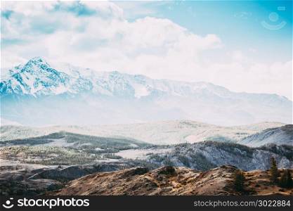 Beautiful mountain range under the clouds. Snowy peaks of rocks. View of mountain valley in Altai Republic.