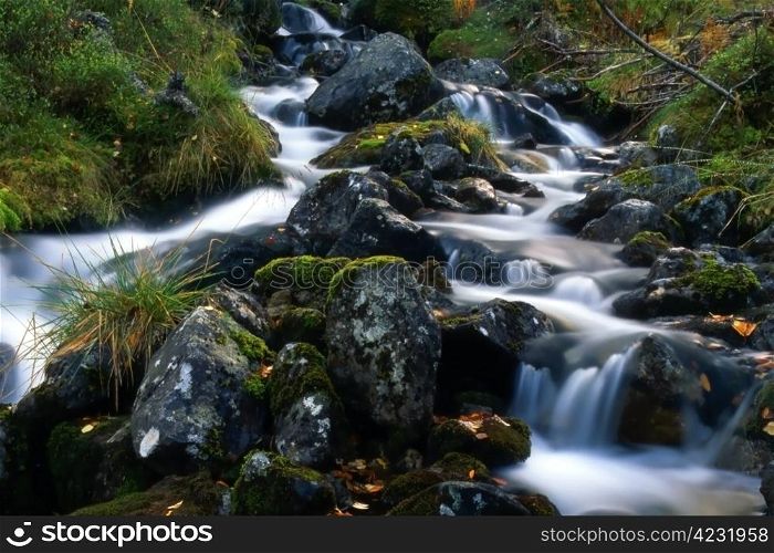 Beautiful mountain stream with many big rocks