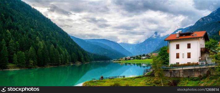 Beautiful mountain village landscape of Villapiccola and Lake Auronzo in Auronzo di Cadore, northern Italy. Nature and countryside panoramic landscape.